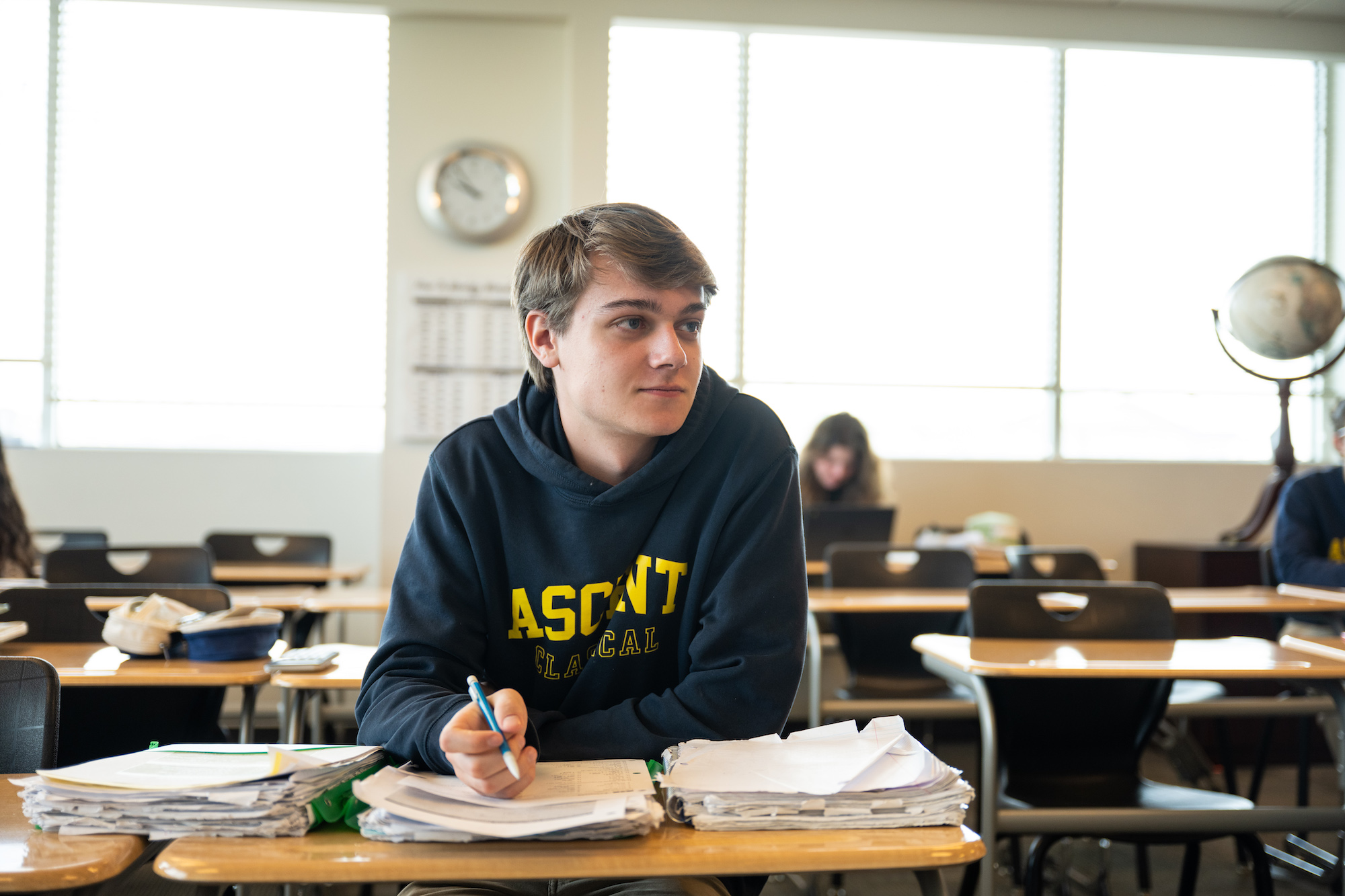 Three smiling boys working on an in class assignment